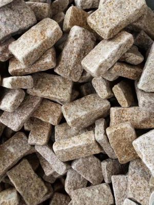 Trummeldatud kollane graniidist kuupkivi